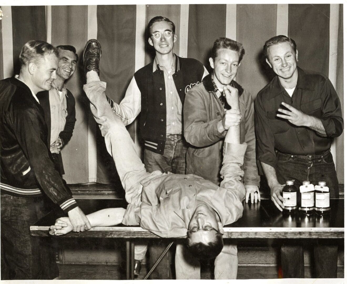 A group of men sitting around a table.