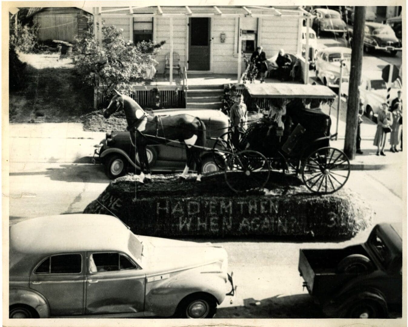 A black and white photo of an old time carriage.