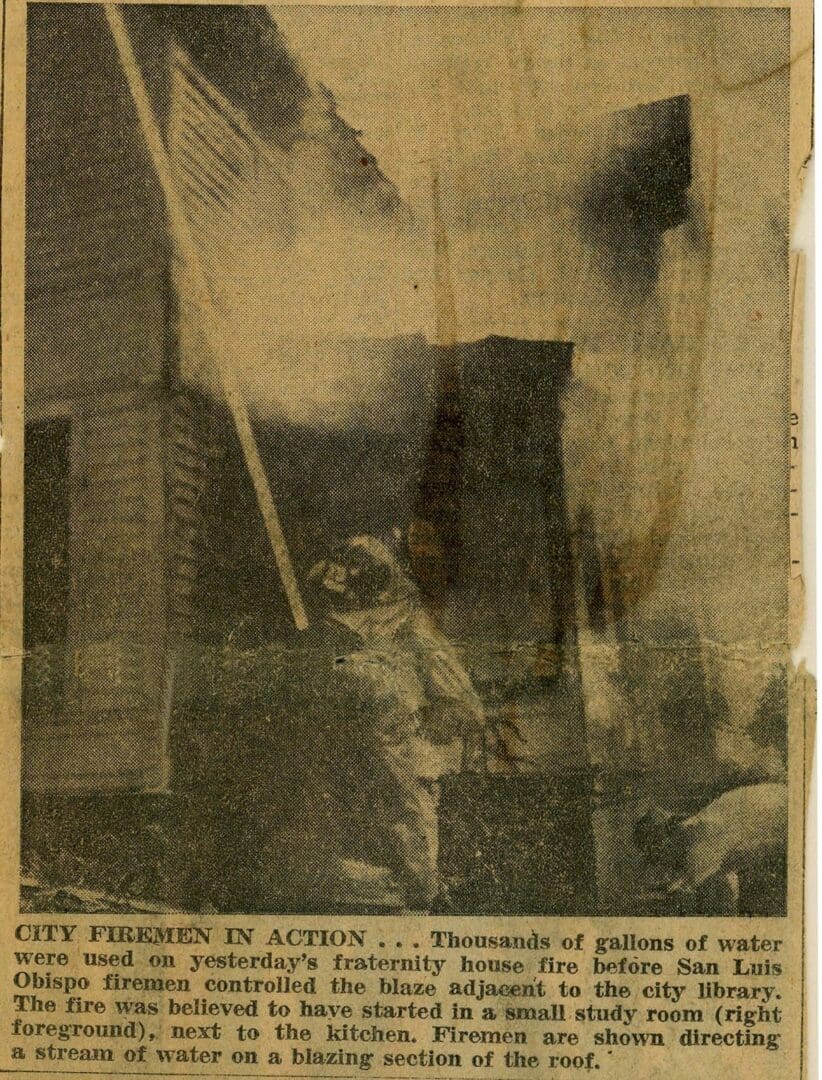 A newspaper clipping of an old building with smoke coming from it.