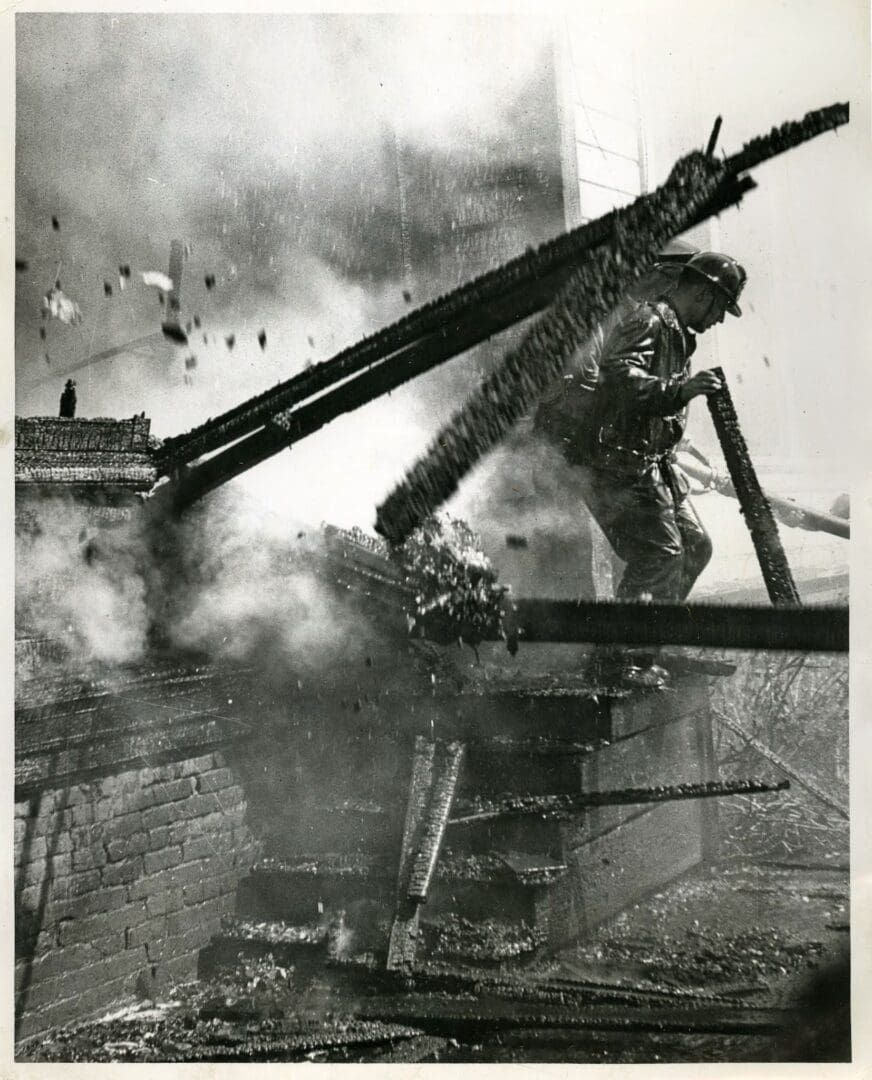 A man standing on top of a fire hydrant.