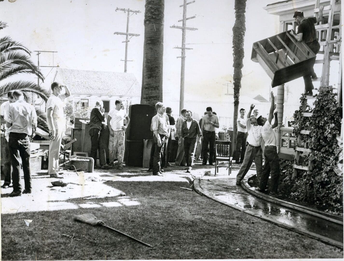 A group of people standing around in the street.