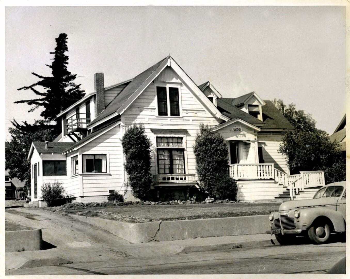 A black and white photo of an old house.