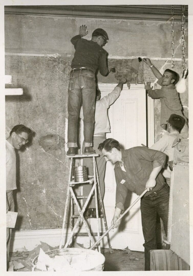A group of men working on the wall.