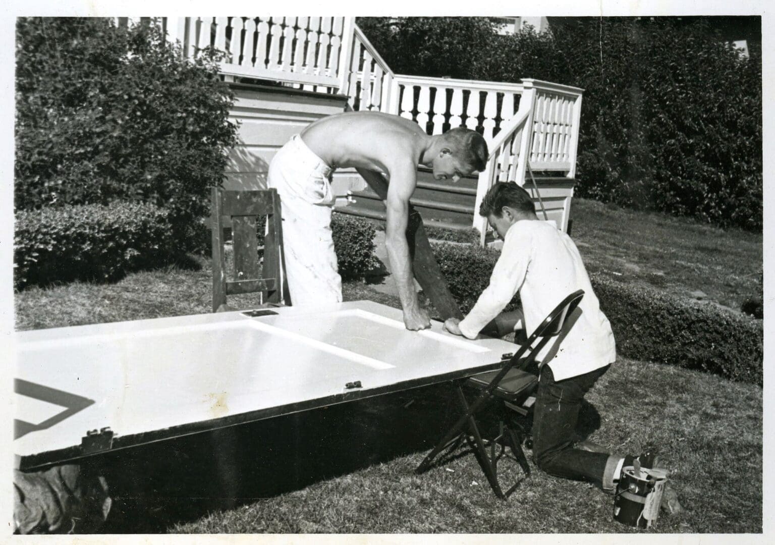 Two men working on a boat in the yard.