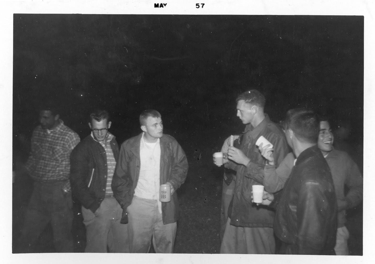 A group of men standing around each other.