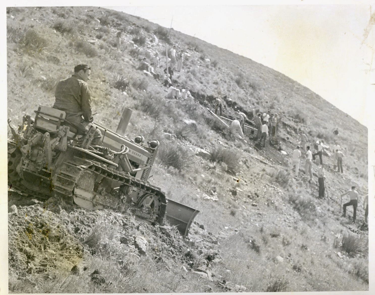 A man standing on top of a tank.