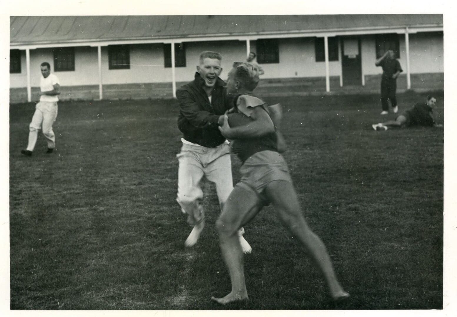 A man and woman playing frisbee in an open field.