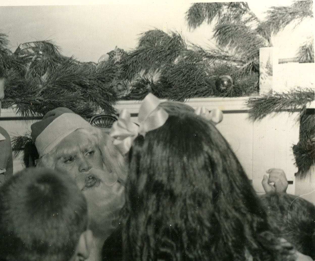 A man in a santa claus suit and beard.