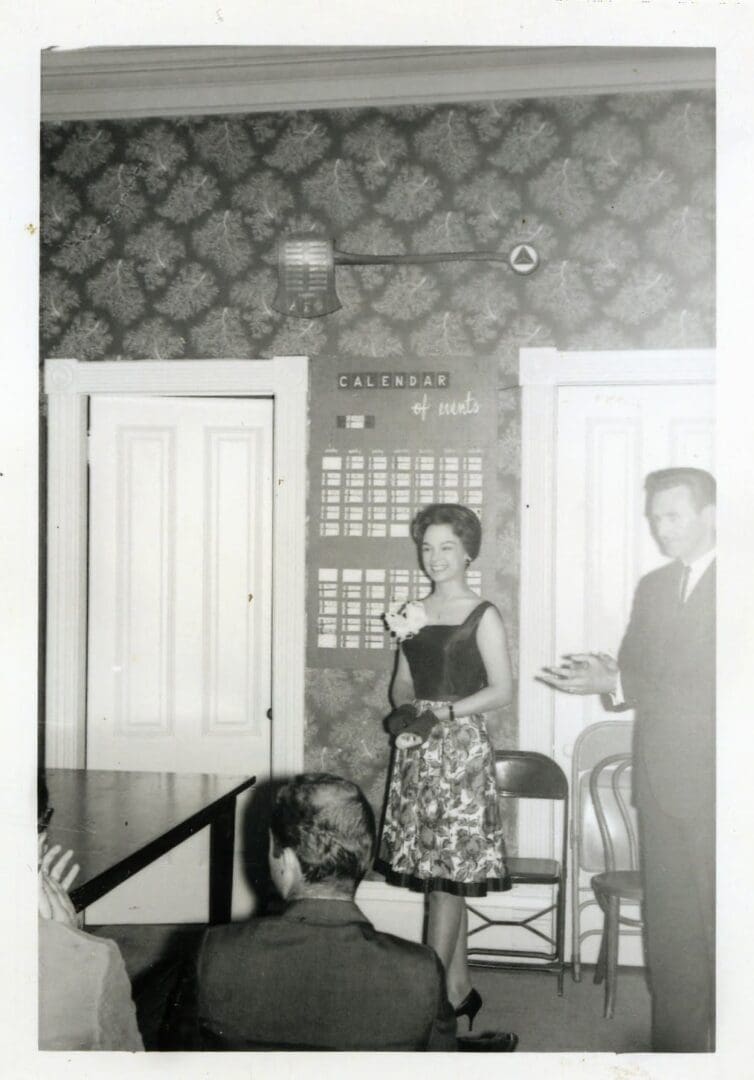 A woman and man standing in front of a door.