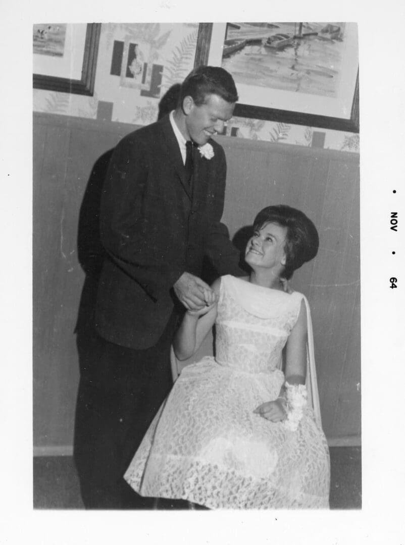 A man and woman in formal wear standing next to each other.