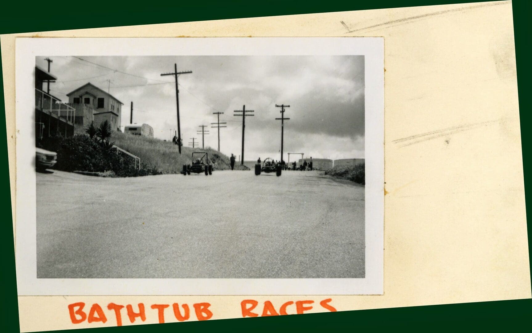 A black and white photo of a street with people on it.