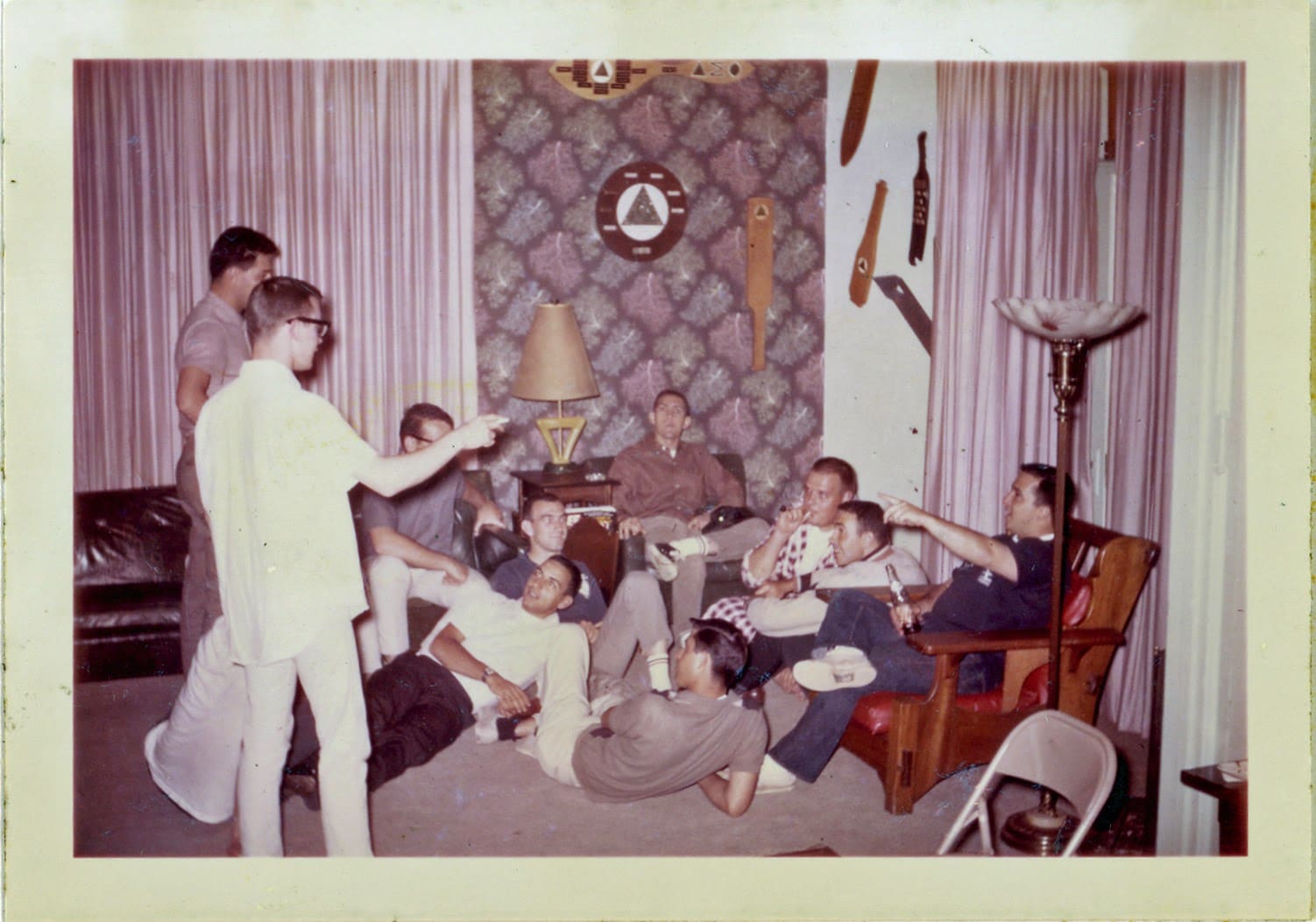 A group of people sitting around in a living room.