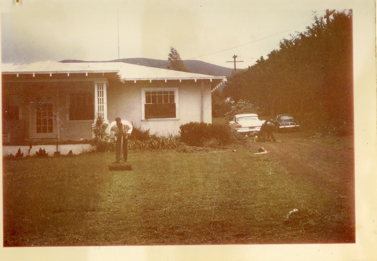 A man standing in front of a house.