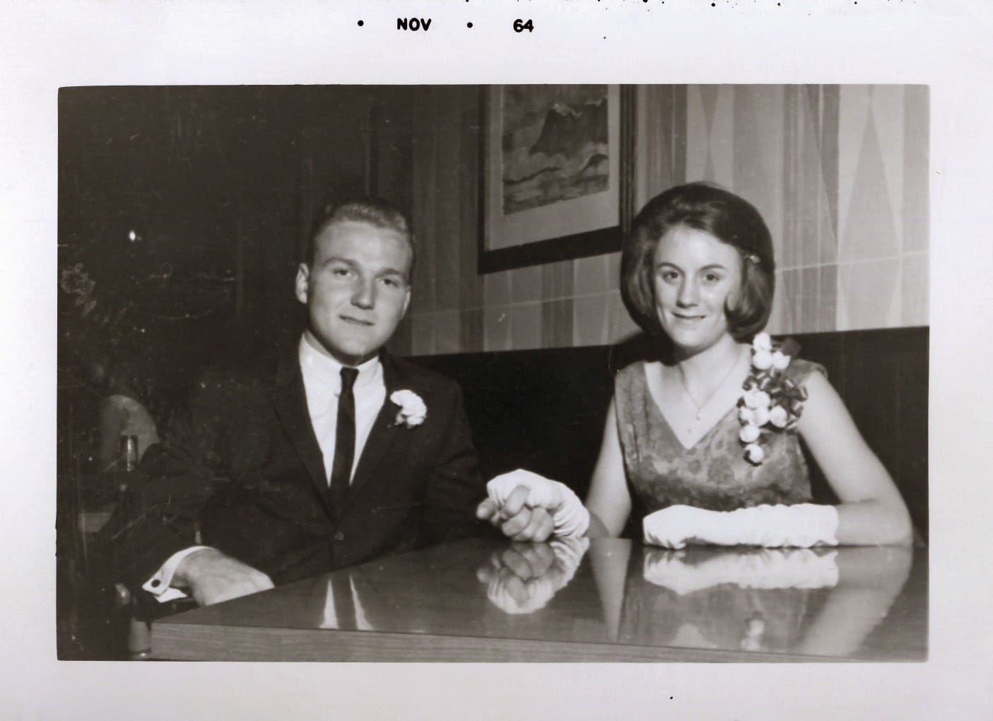 A man and woman sitting at the table.
