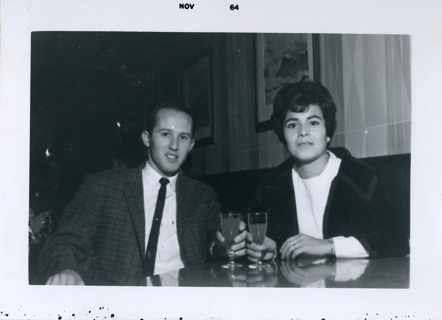 Two men sitting at a table with drinks.