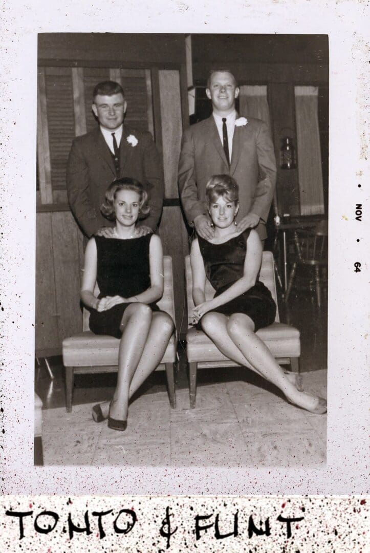 A group of people sitting on top of benches.