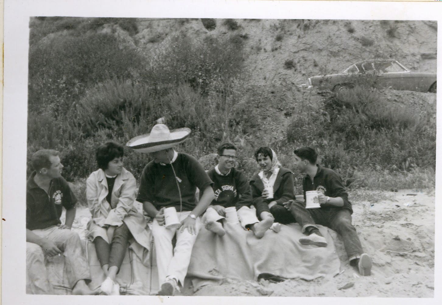 A group of people sitting on the ground.