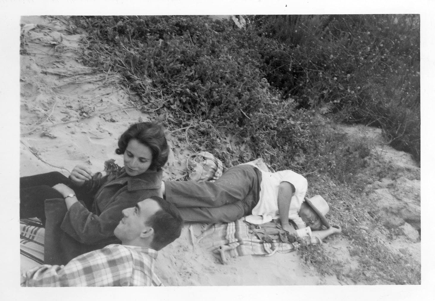 A man and woman laying on the ground.