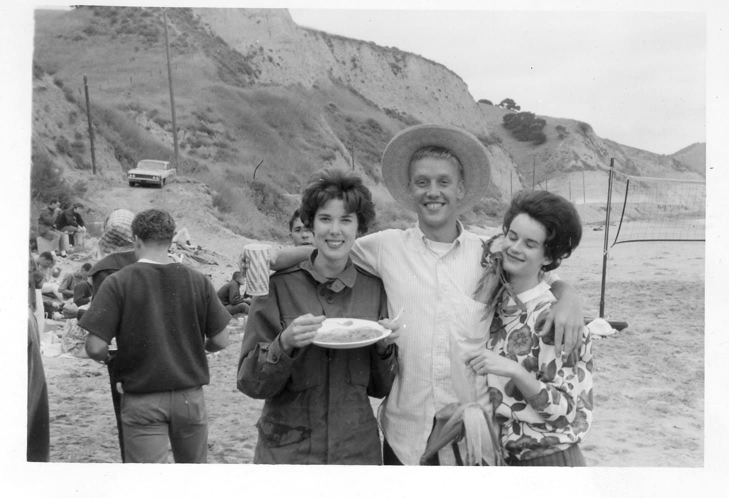 A man and two women posing for the camera.