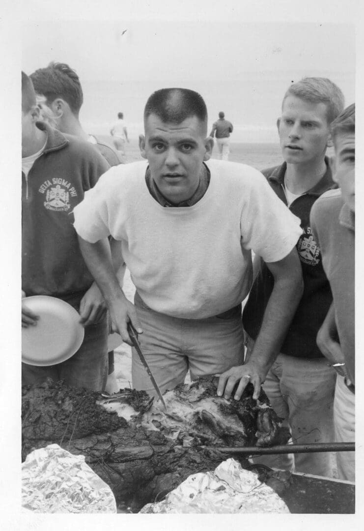 A man is holding a fish on the grill