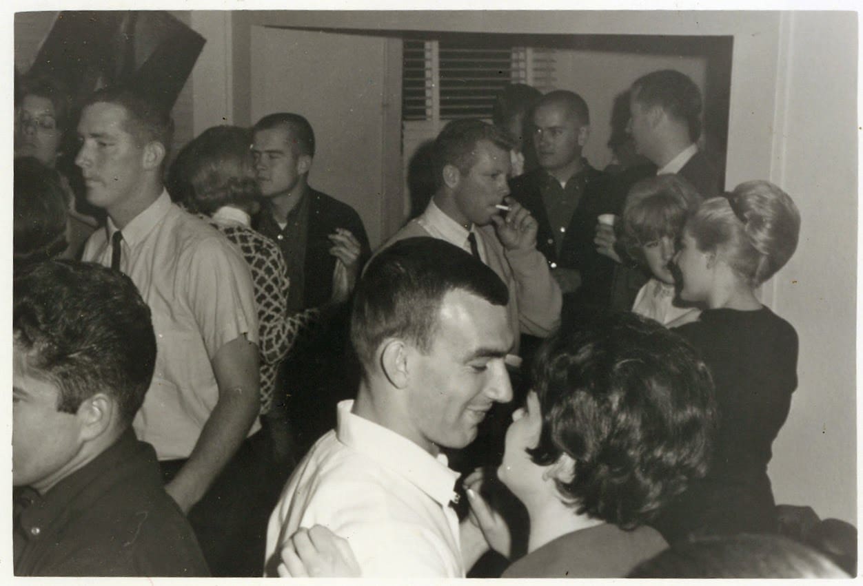 A group of people standing around each other.