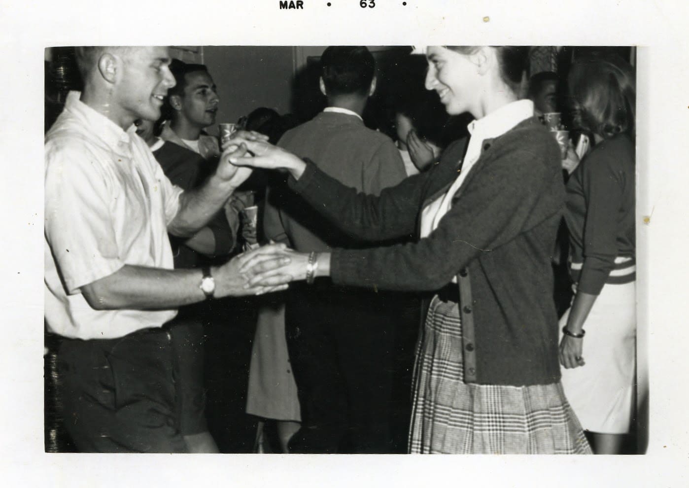 A group of people dancing in a room.