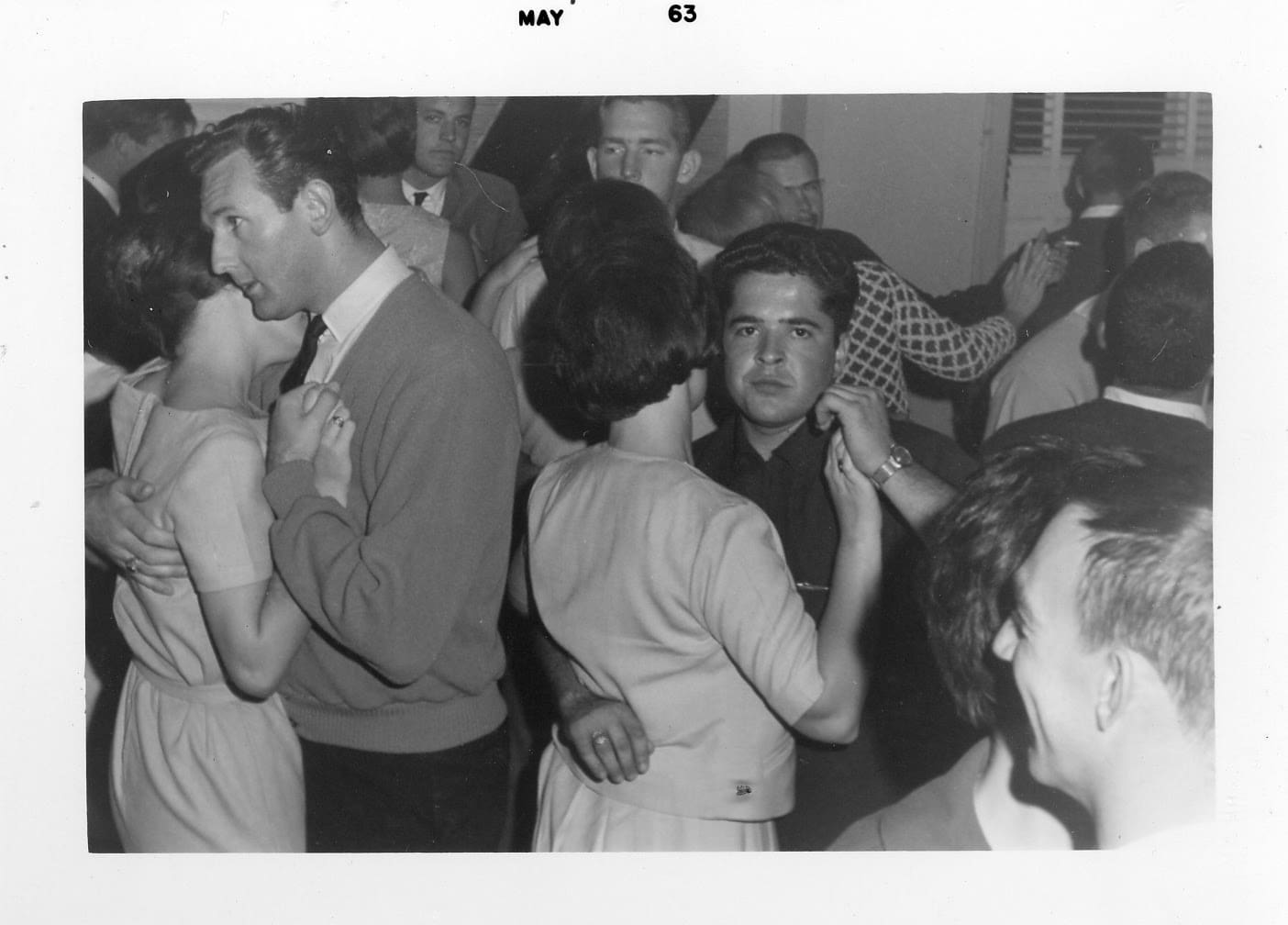 A group of people dancing in a room.