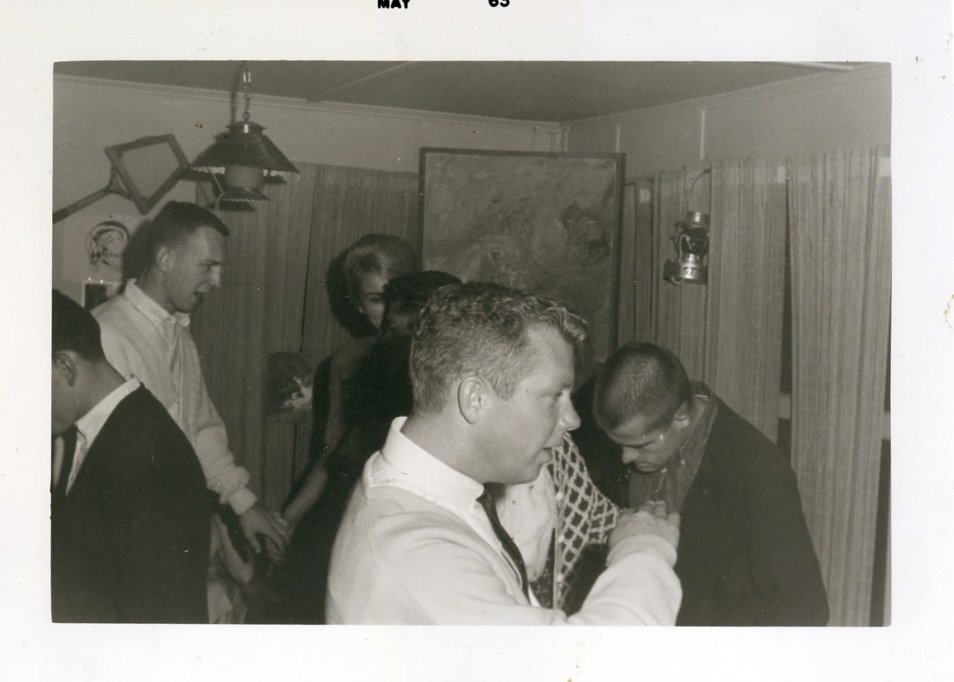 A group of people standing around each other.