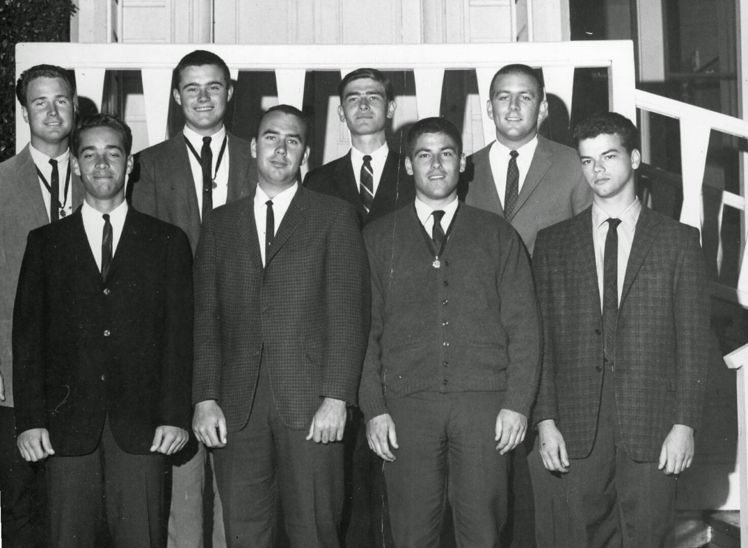 A group of men in suits and ties standing next to each other.