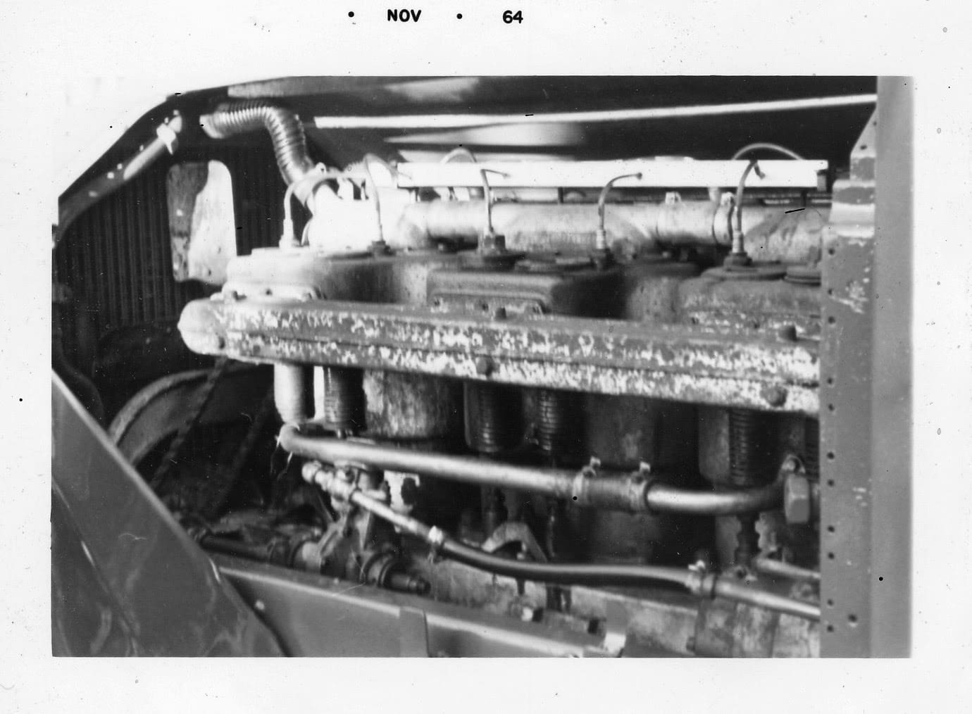A black and white photo of an old car engine.