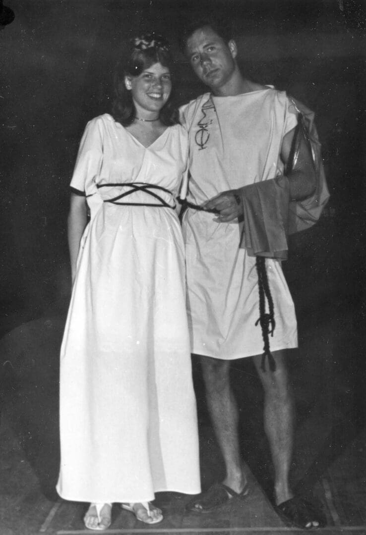 A man and woman dressed in roman clothes.