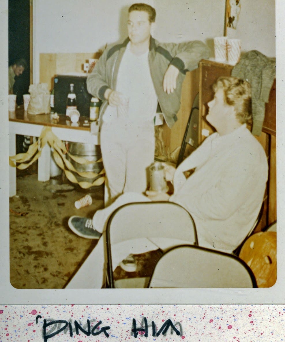 A man and woman sitting in chairs with a table.