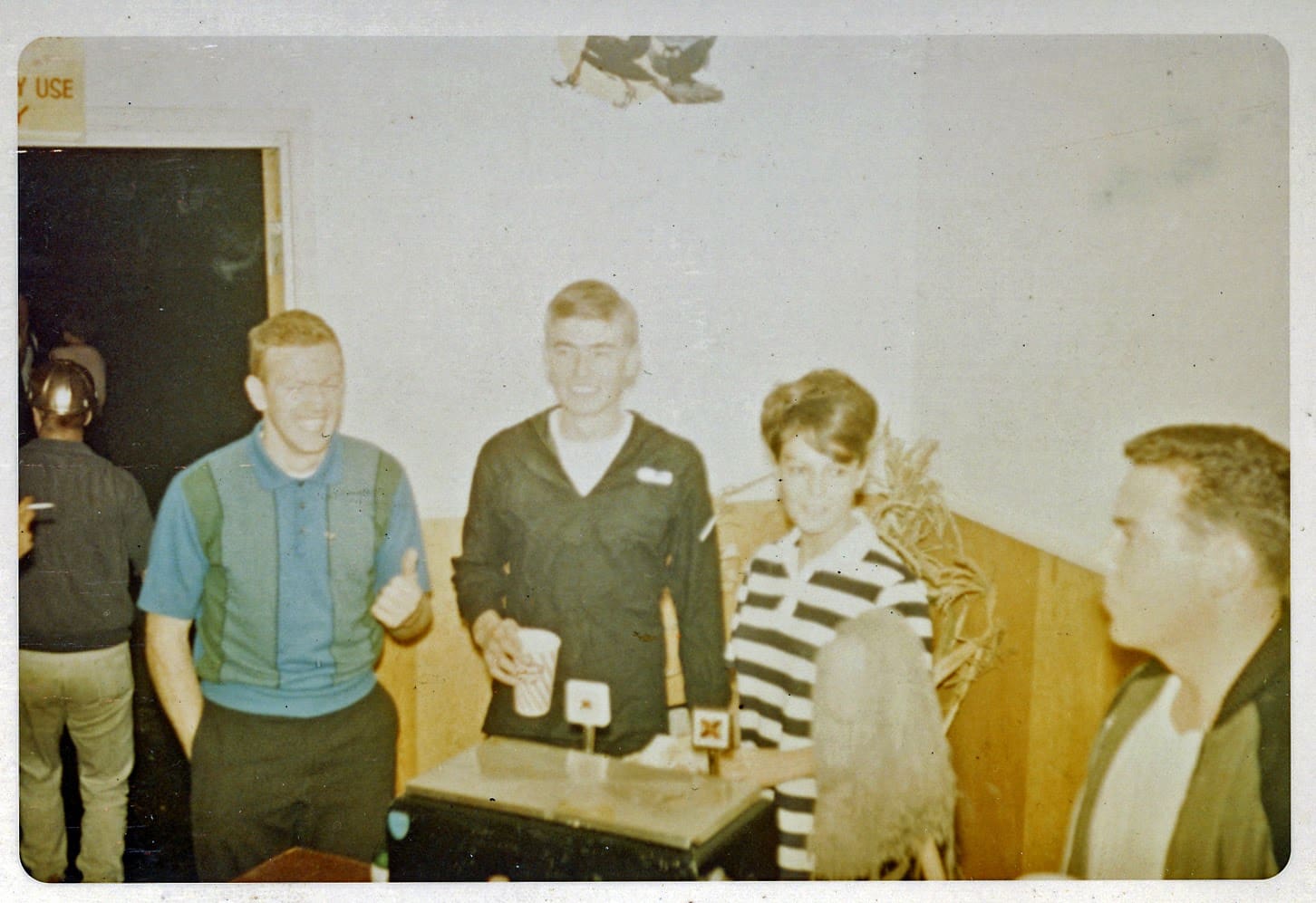 A group of people standing around a table.