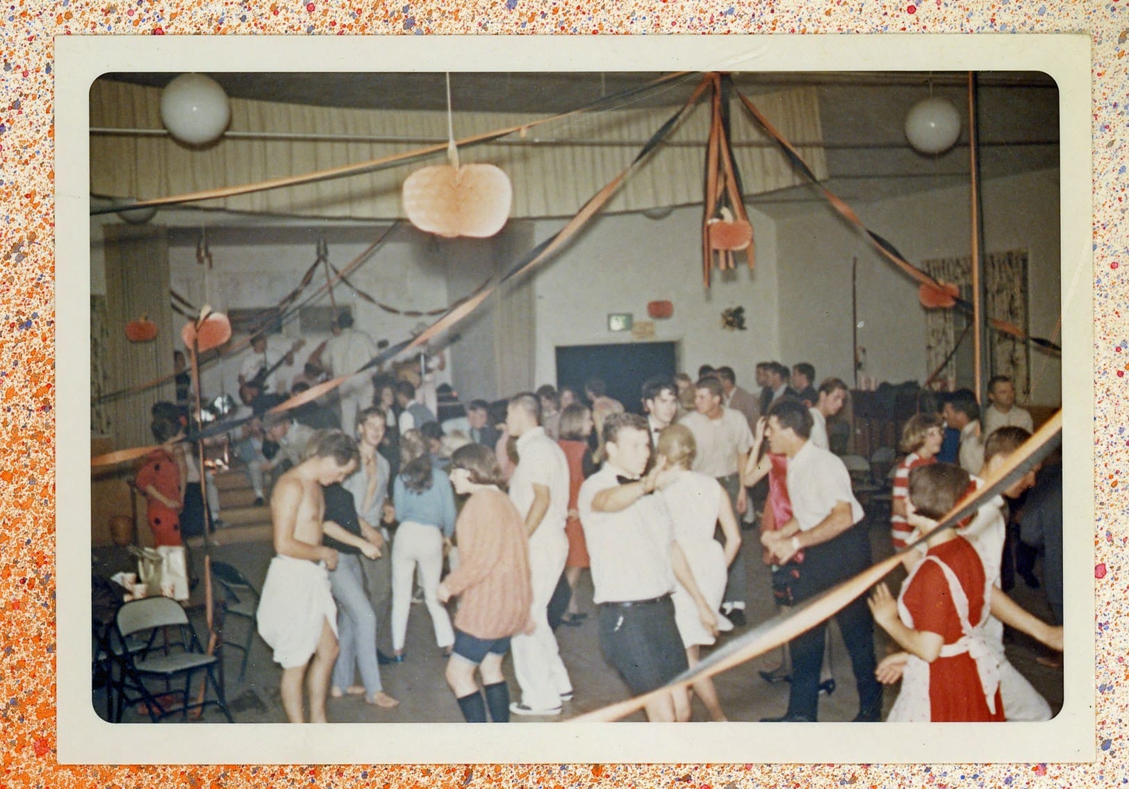 A group of people dancing in a room.