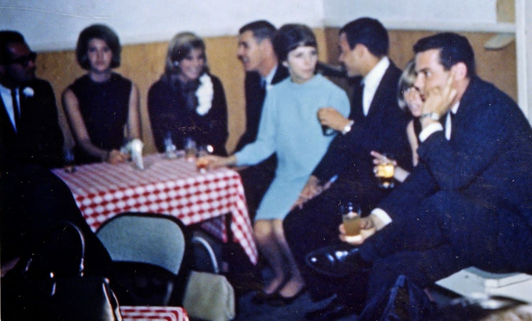 A group of people sitting around a table.