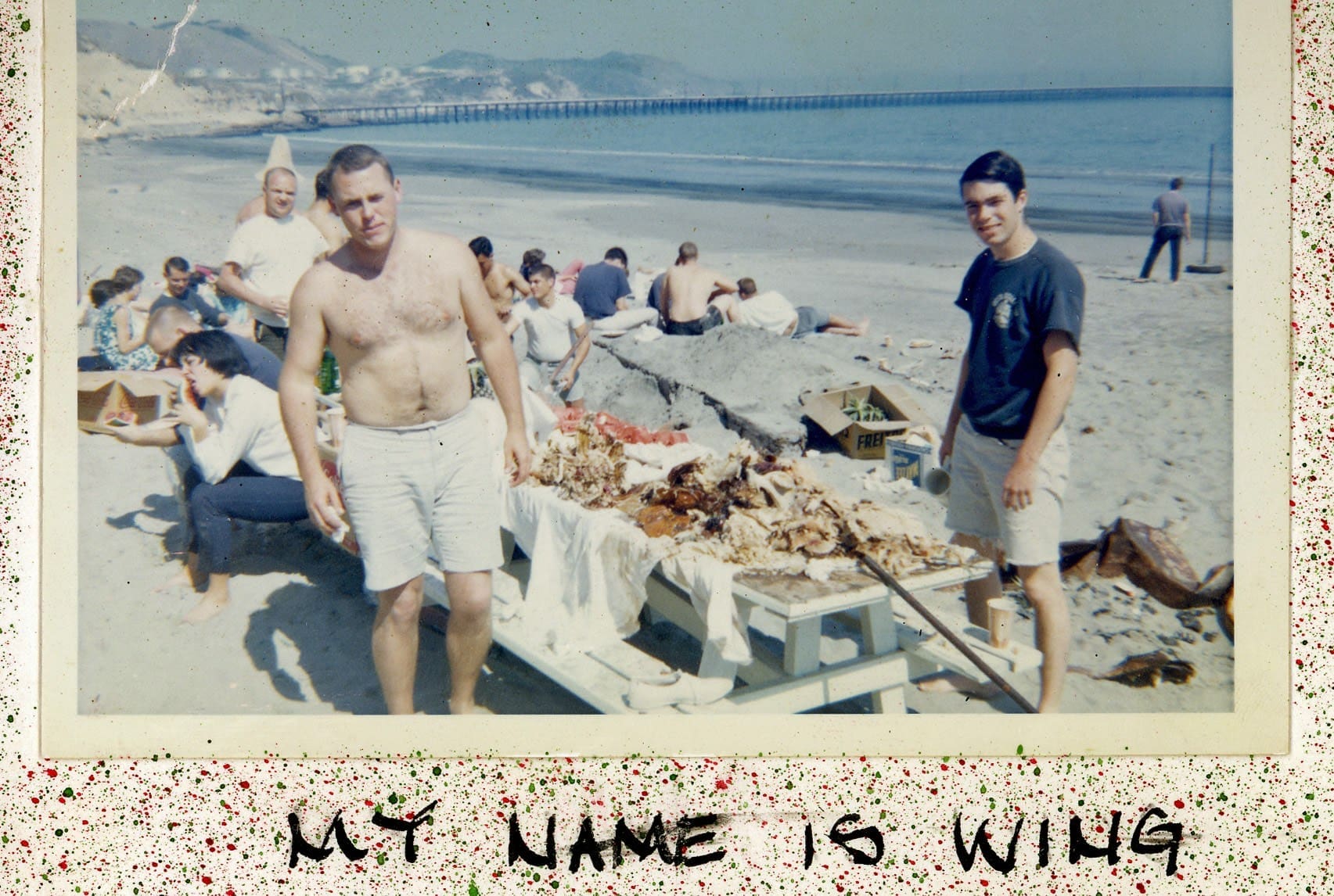 A man and two men standing on the beach.