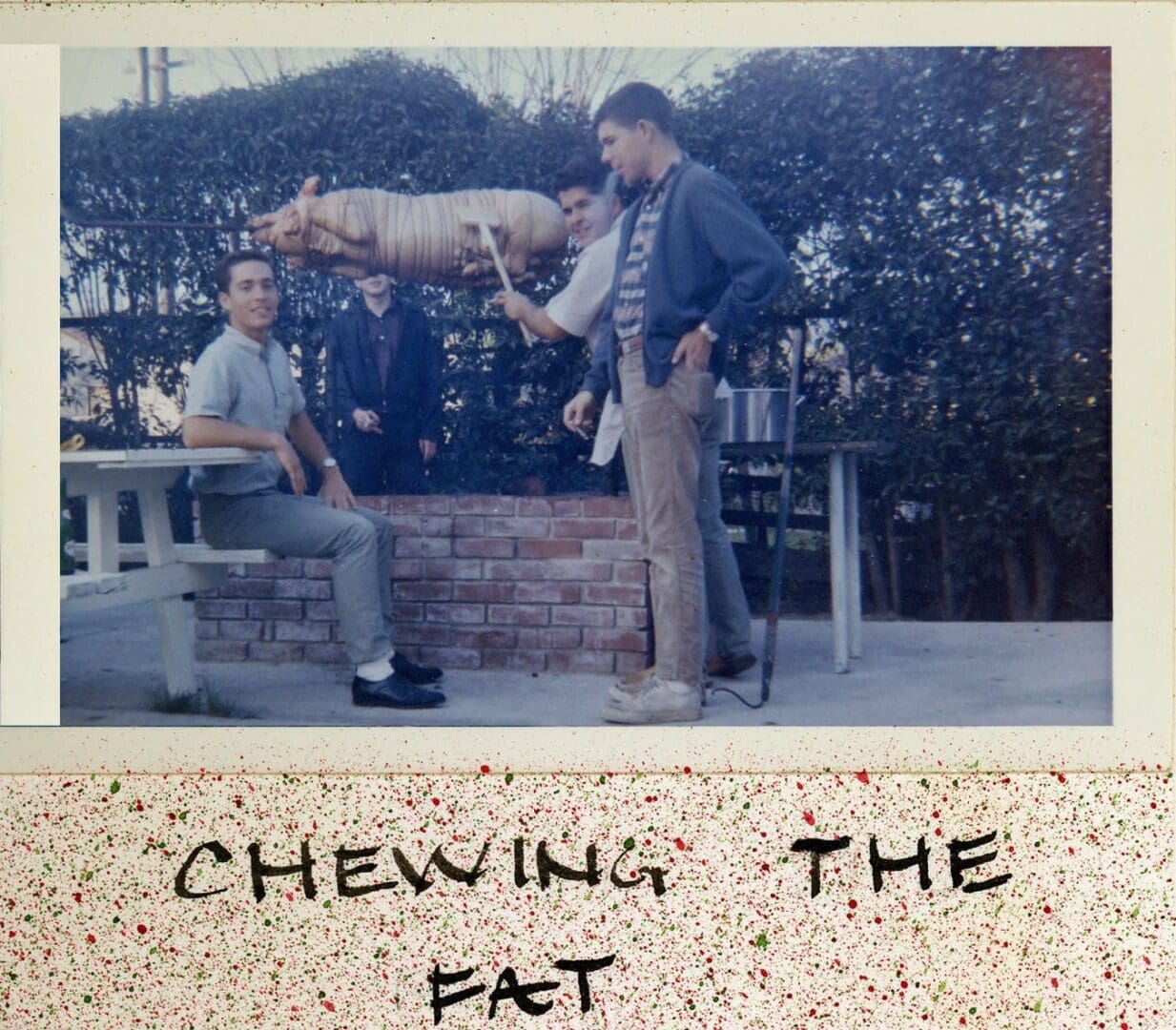 A picture of two men and one man holding a pig.