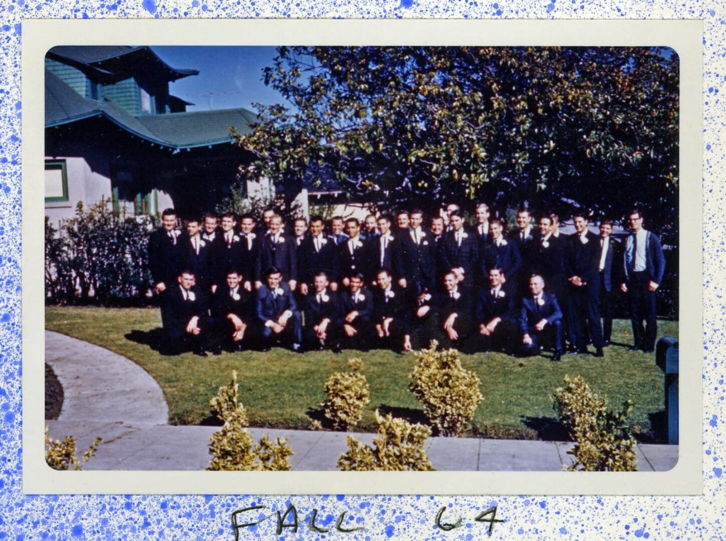 A group of people in suits and ties posing for a picture.