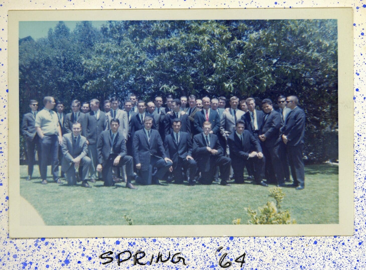 A group of men in suits and ties standing next to each other.