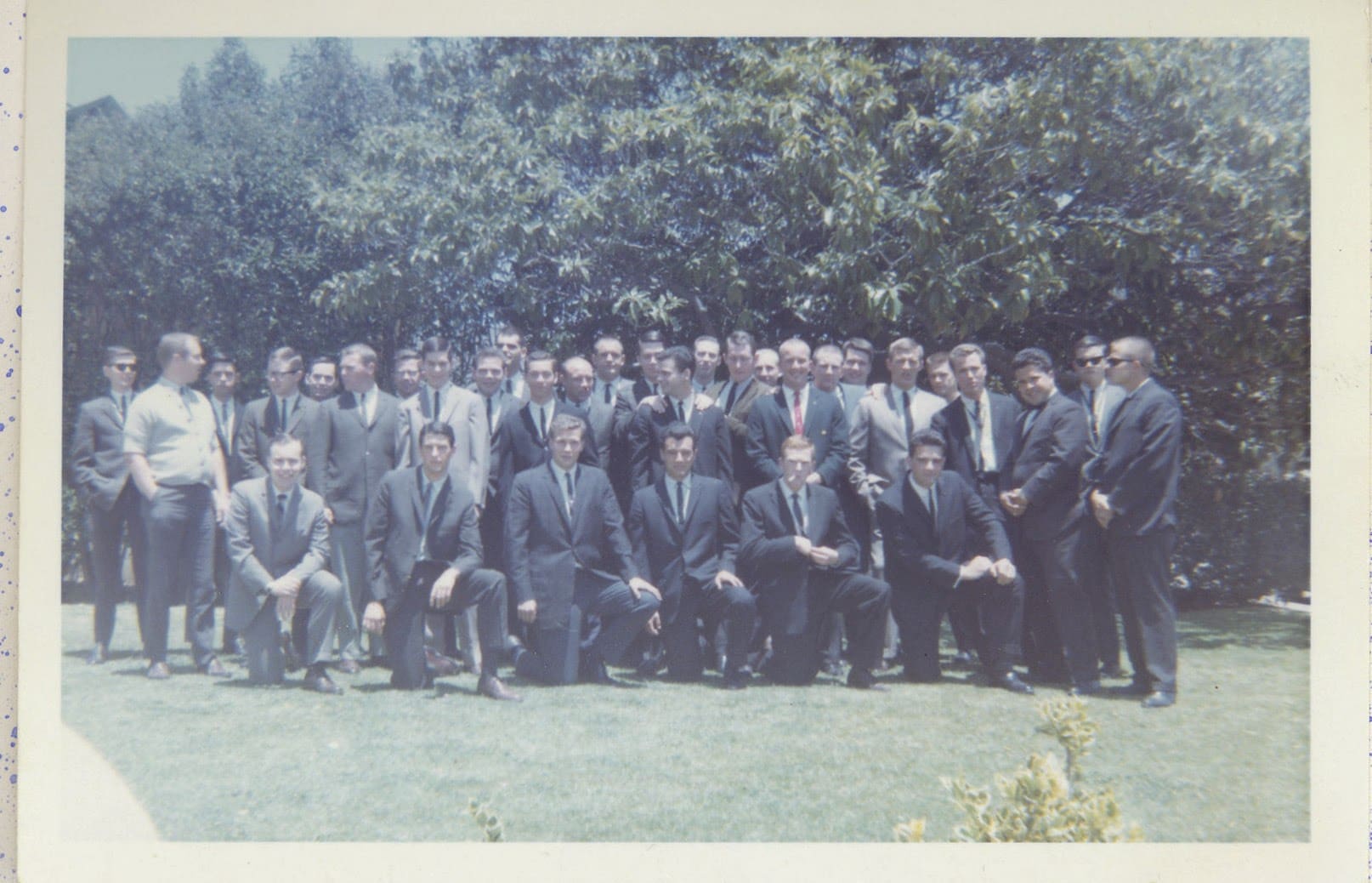 A group of men in suits posing for a picture.