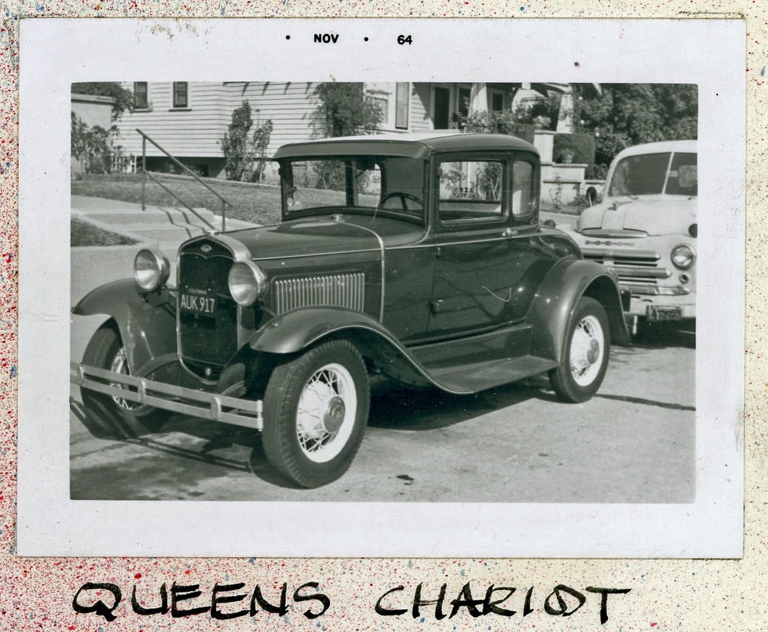 A black and white photo of an old car.