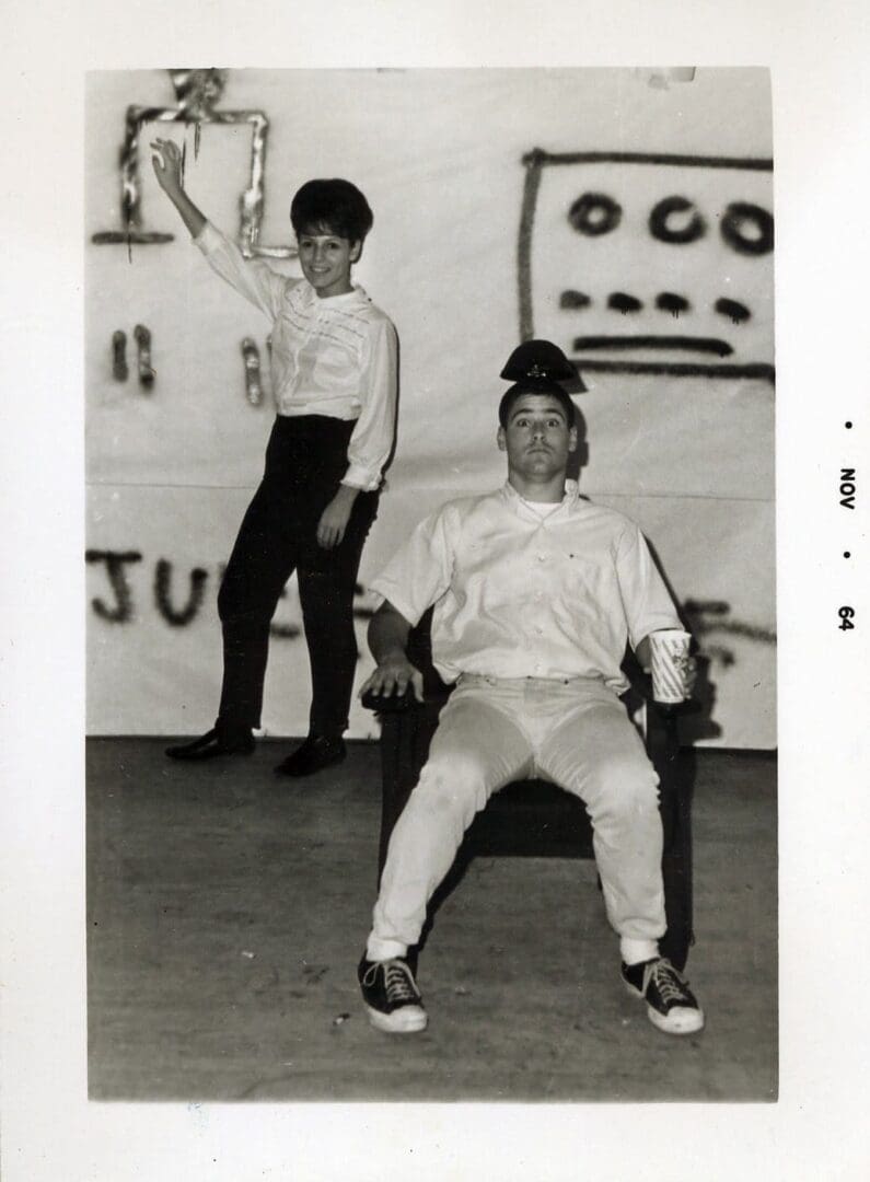 A man and woman in white shirts and shorts.
