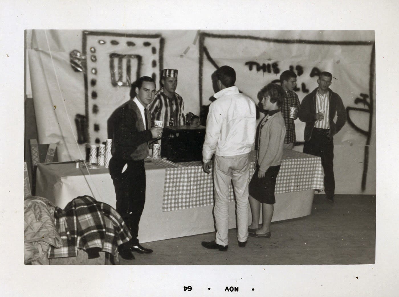 A group of people standing around a table.