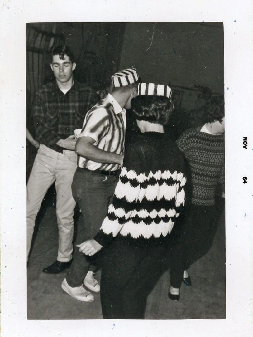 A group of people standing around each other.