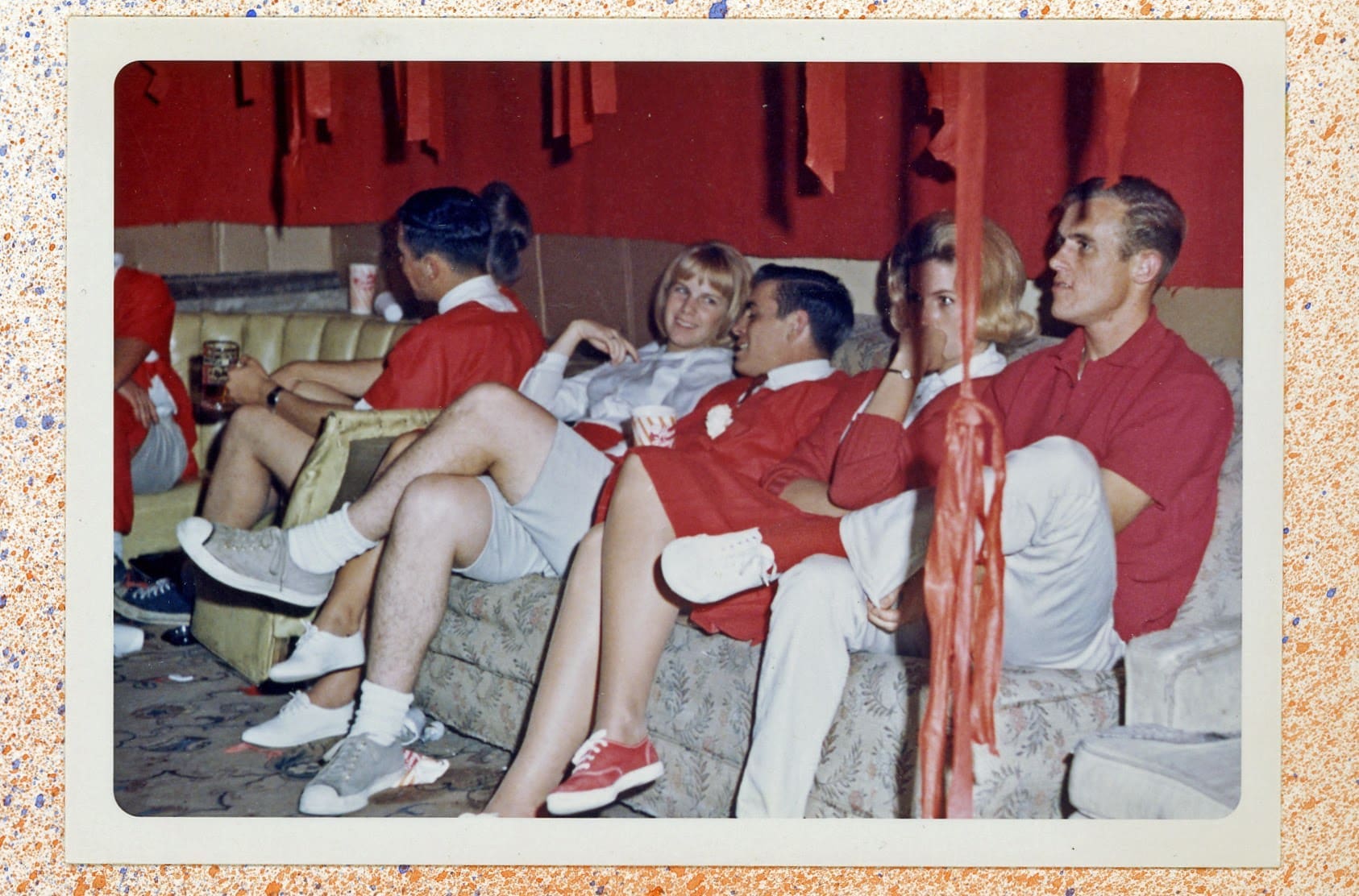 A group of people sitting on top of a couch.
