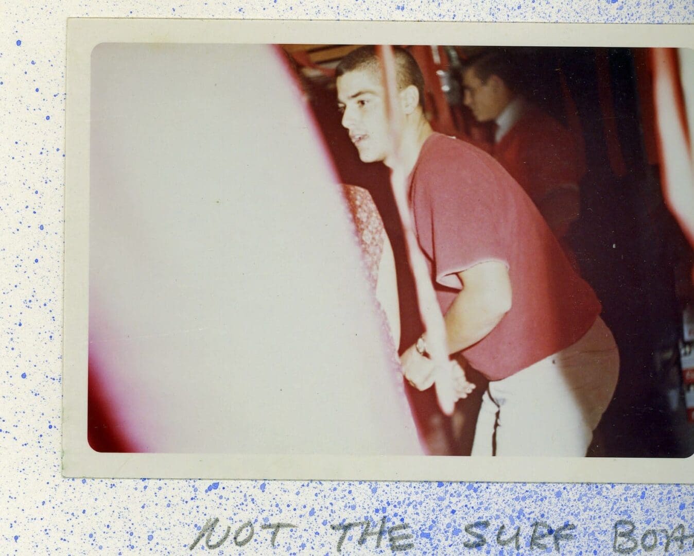 A young man holding onto a baseball bat.