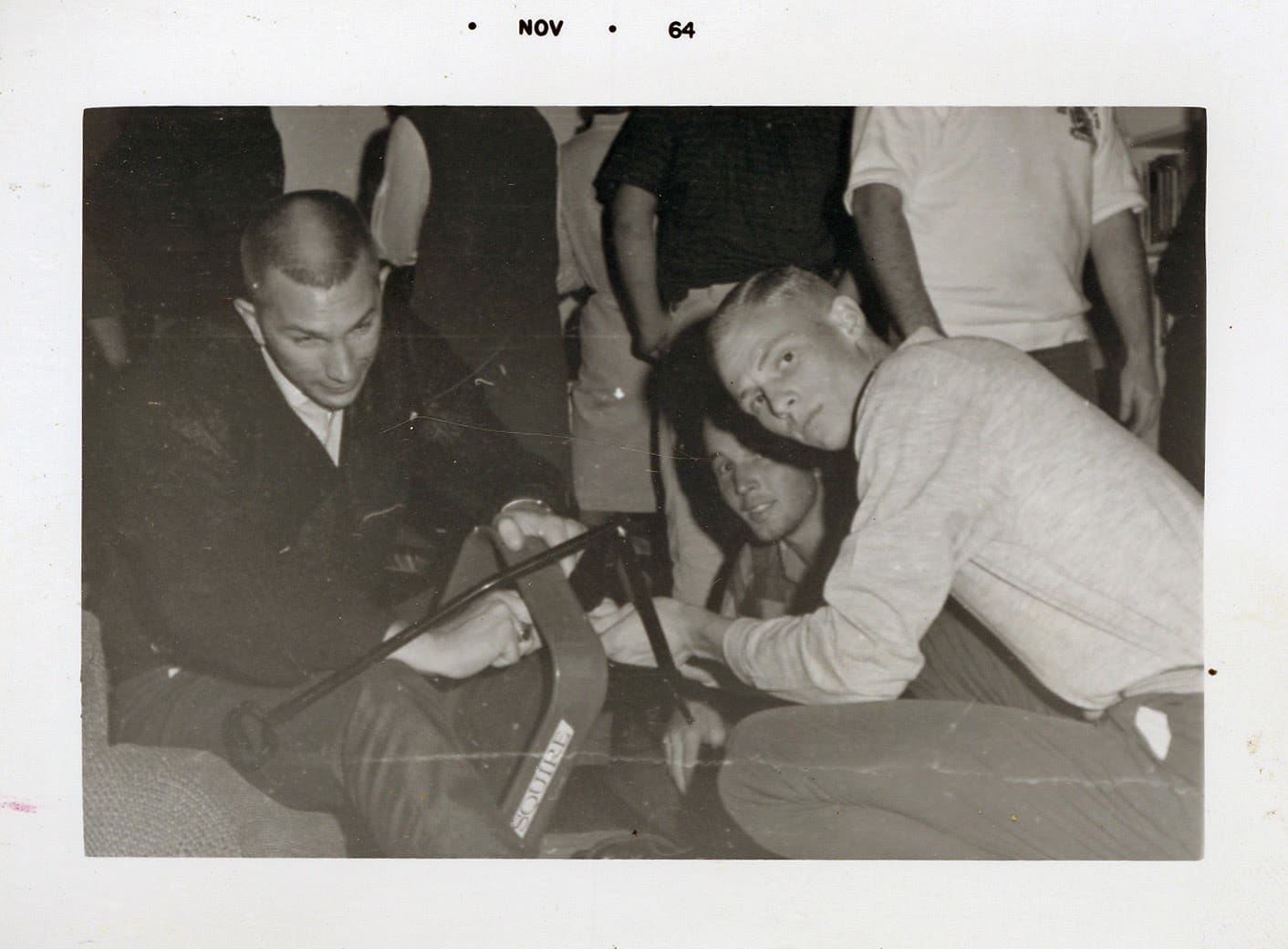 A group of men sitting on the ground.