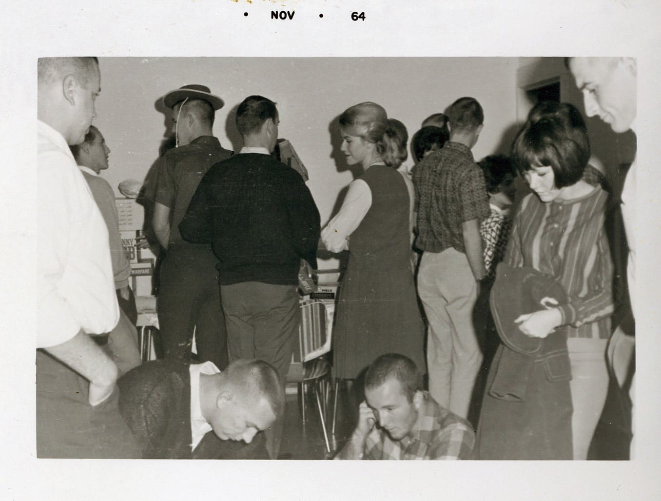 A group of people standing around each other.