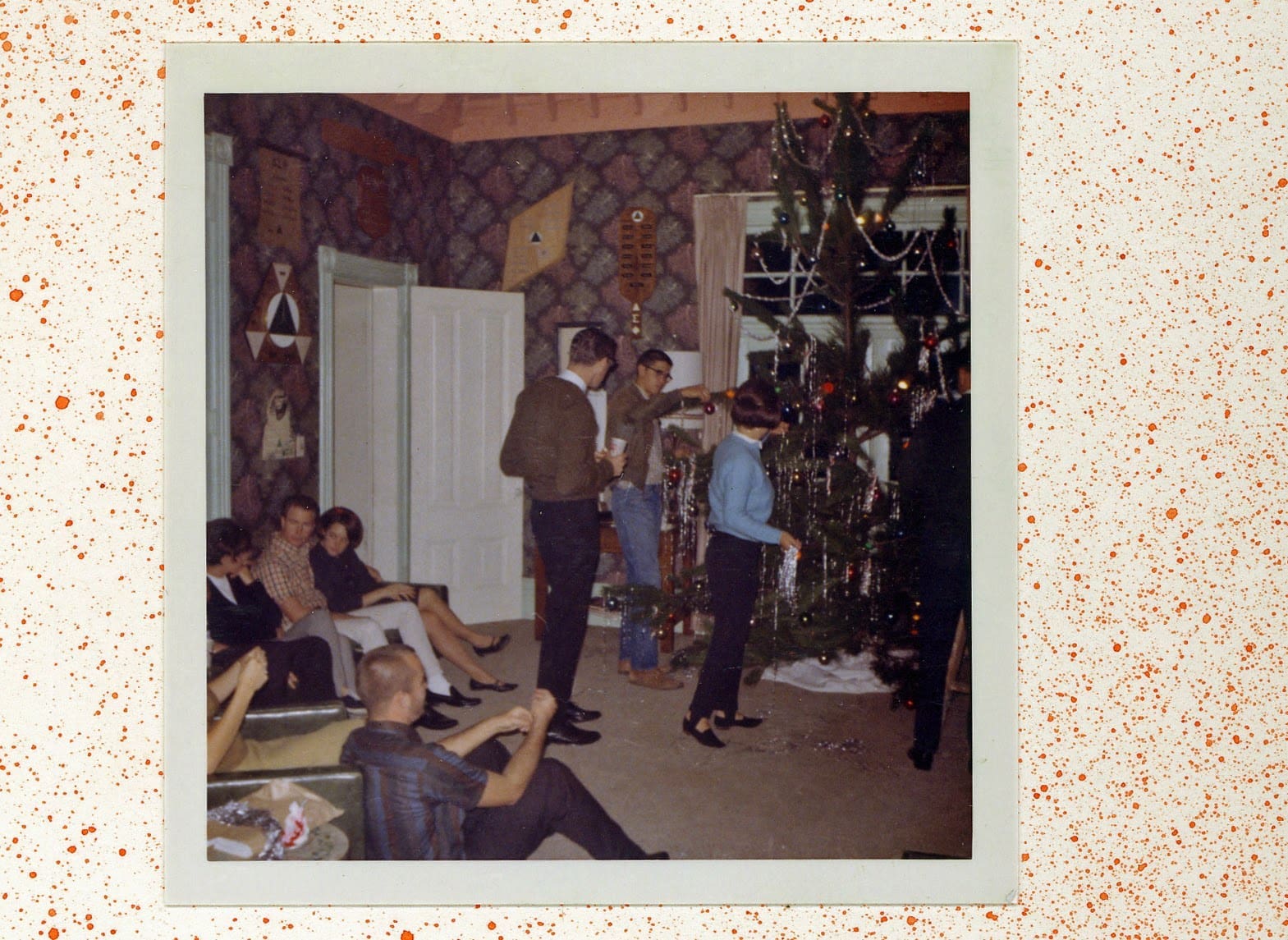 A group of people in a room with some decorations
